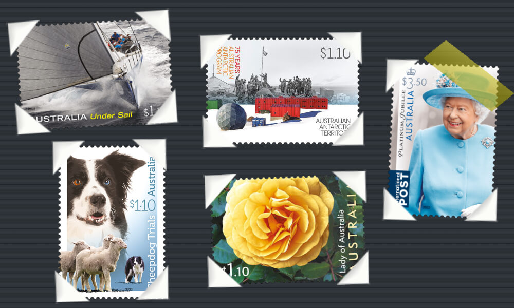 A apparent page from a photo album in which several Australian stamps have been placed using photographic corner mounts. The stamps depict photos of a yacht, a dog, an Antarctic base, a rose, and the late Queen Elizabeth the Second.